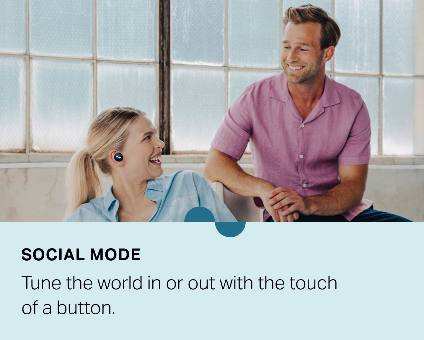 Person wearing NURATRUE earbuds with Social Mode on, talking to another person — "Social Mode: Tune the world in or out with the touch of a button."