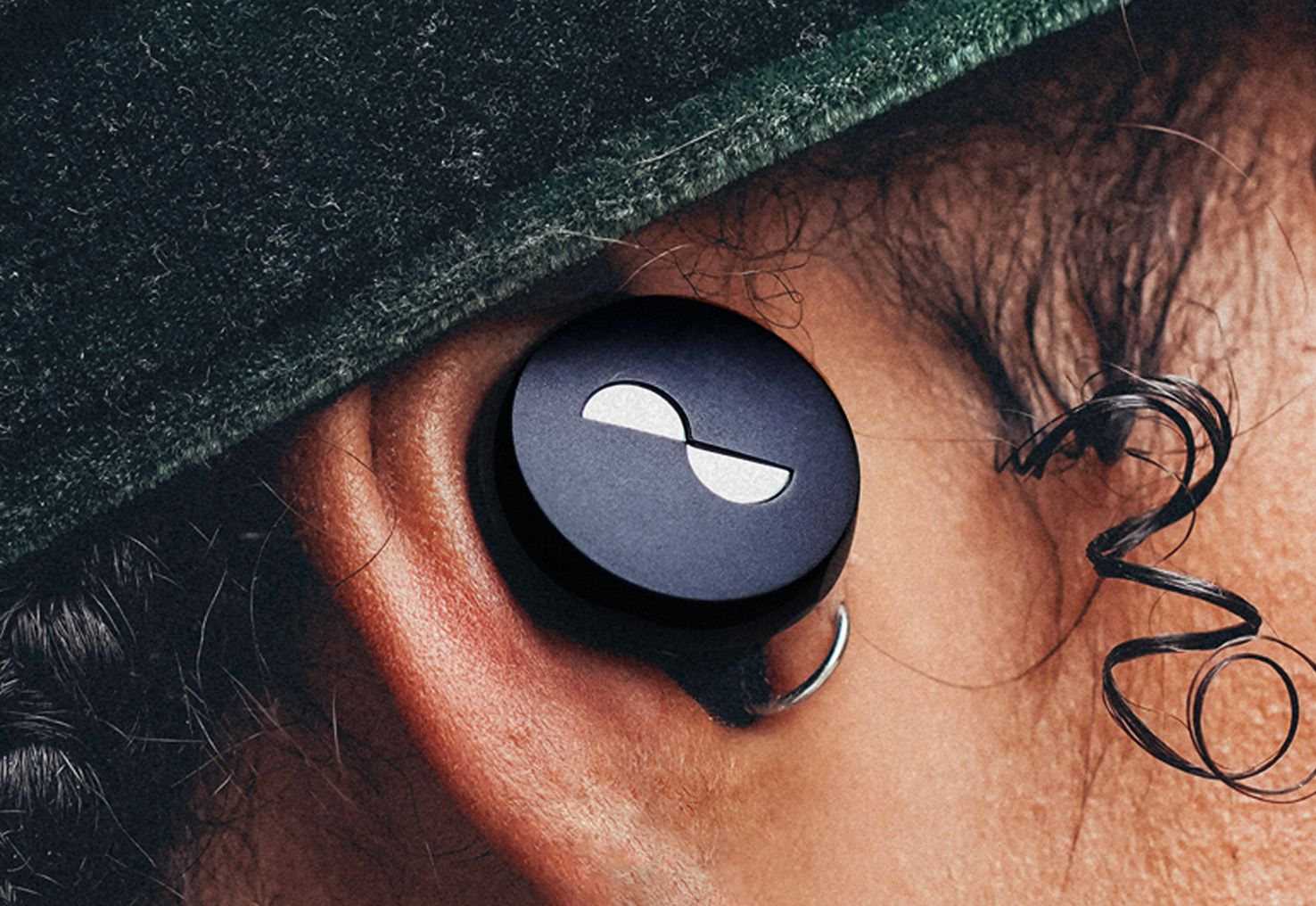 Close-up shot of NURATRUE earbuds in someone's ears