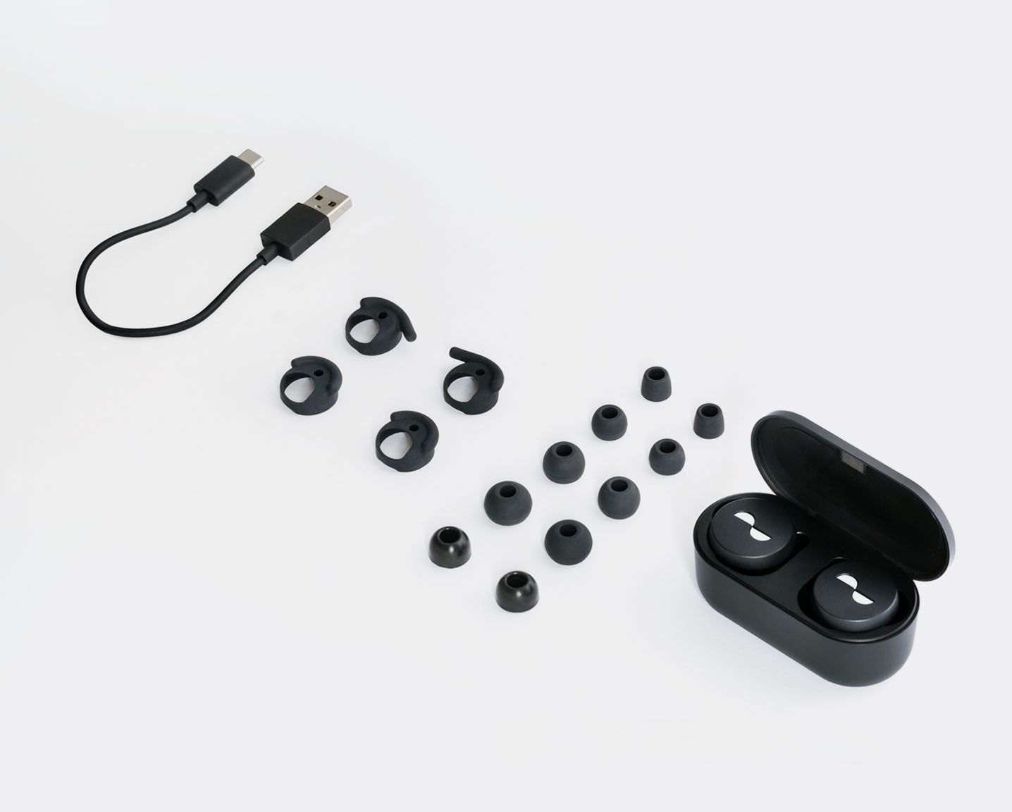 Angled flat lay of what comes in the box with NURATRUE earbuds