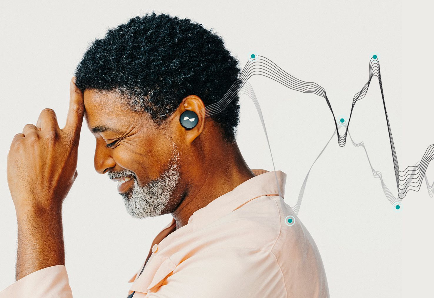 Person with NURATRUE earbuds in ears, with the diagram of Otoacoustic Emissions (OAEs) coming from their ear