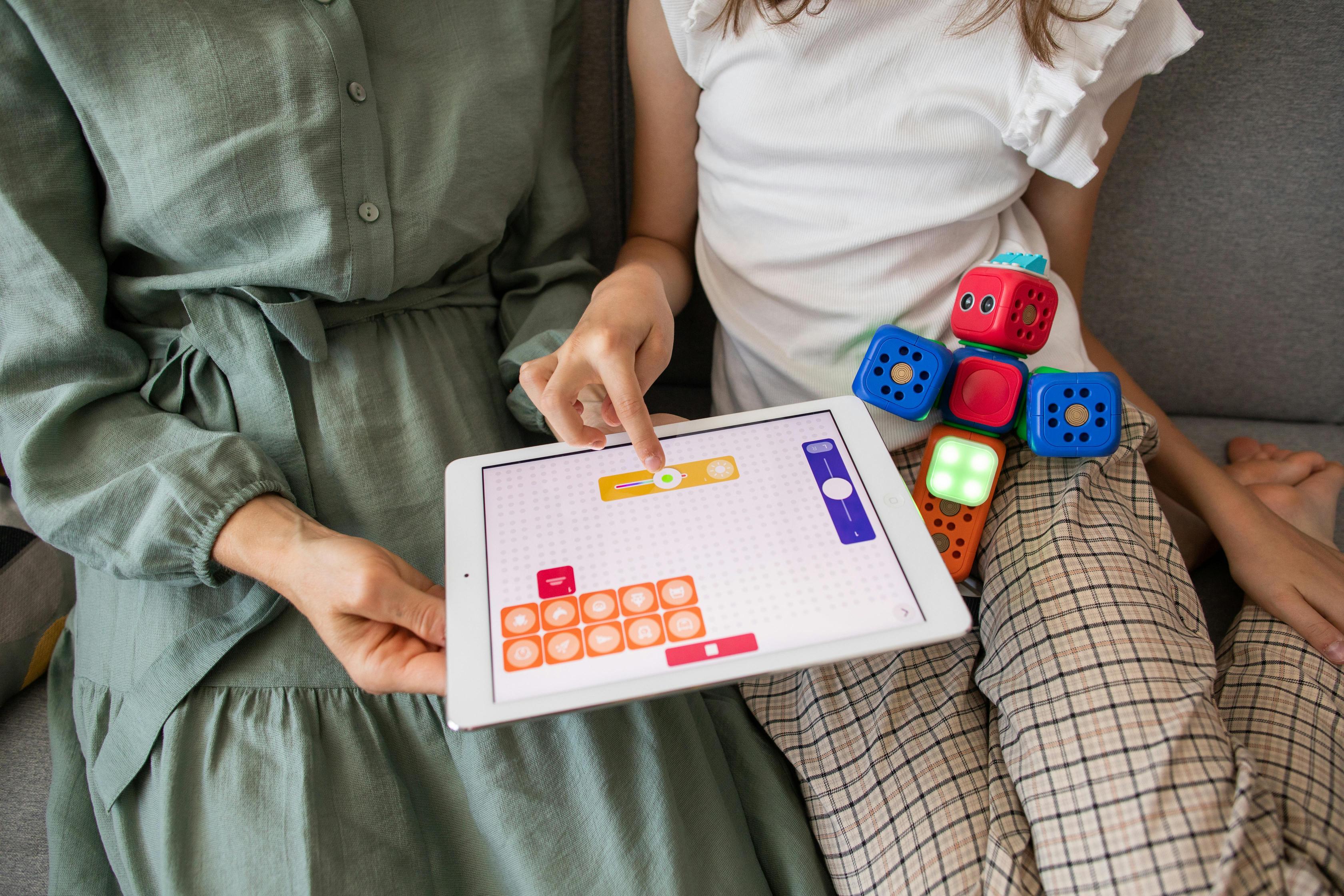 A parent and child learning on tablet. 