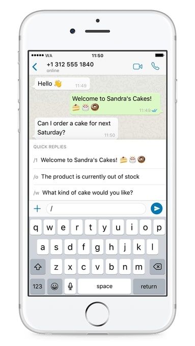 A WhatsApp Business chat on an iPhone with the quick-replies panel open over the keyboard, listing /1 "Welcome to Sandra's Cakes!", /o "The product is currently out of stock" and /w "What kind of cake would you like?"