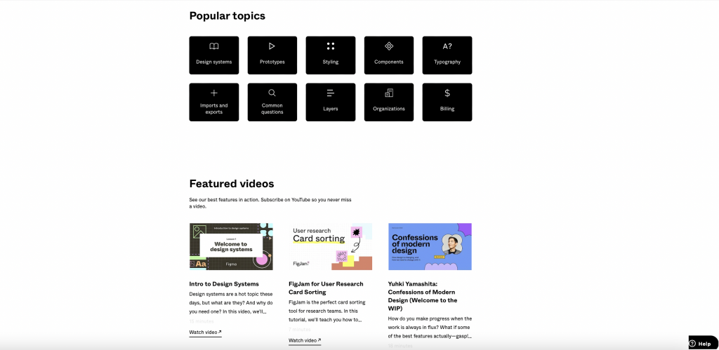 Figma Learn's Popular topics tiles β design systems, prototypes, styling, components, typography, imports and exports, common questions, layers, organizations and billing β above a row of featured videos