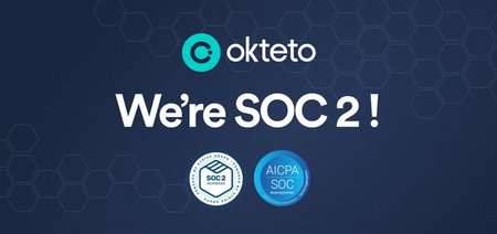 The image features the text "Okteto: We're SOC 2!" in bold white letters on a dark blue background with a hexagonal pattern. The Okteto logo, a teal circle with a stylized "C," is placed at the top. Below the main text, there are two SOC 2 certification badges: one labeled "SOC 2 Type II Audited" and the other "AICPA SOC for Service Organizations." The design highlights Okteto's achievement of SOC 2 certification, indicating their compliance with key security and privacy standards.