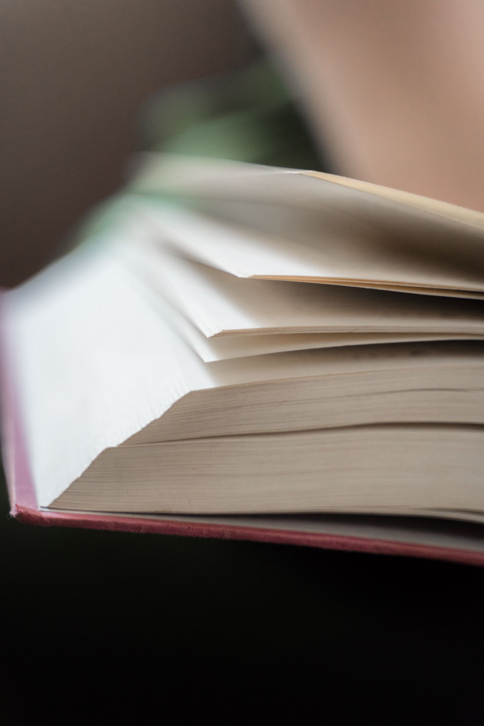 A close detail of bound paper and pages being turned