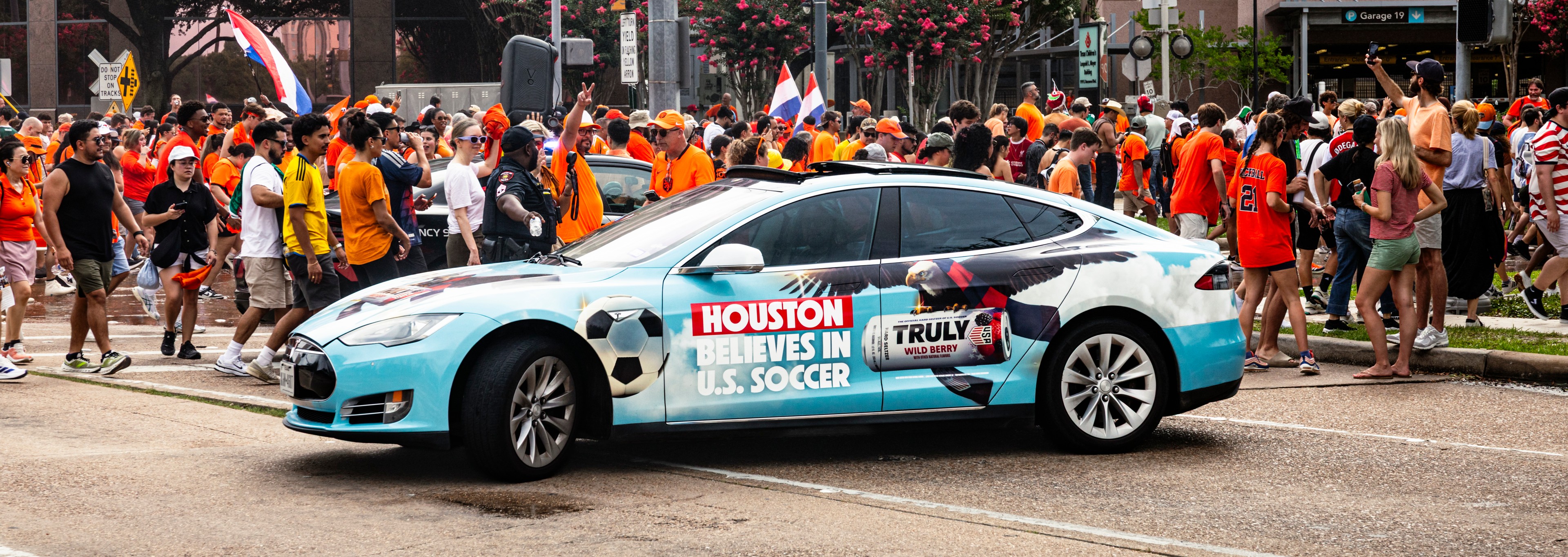 Truly Hard Seltzer branded vehicle at 2026 World Cup match in Houston surrounded by fans and foot traffic