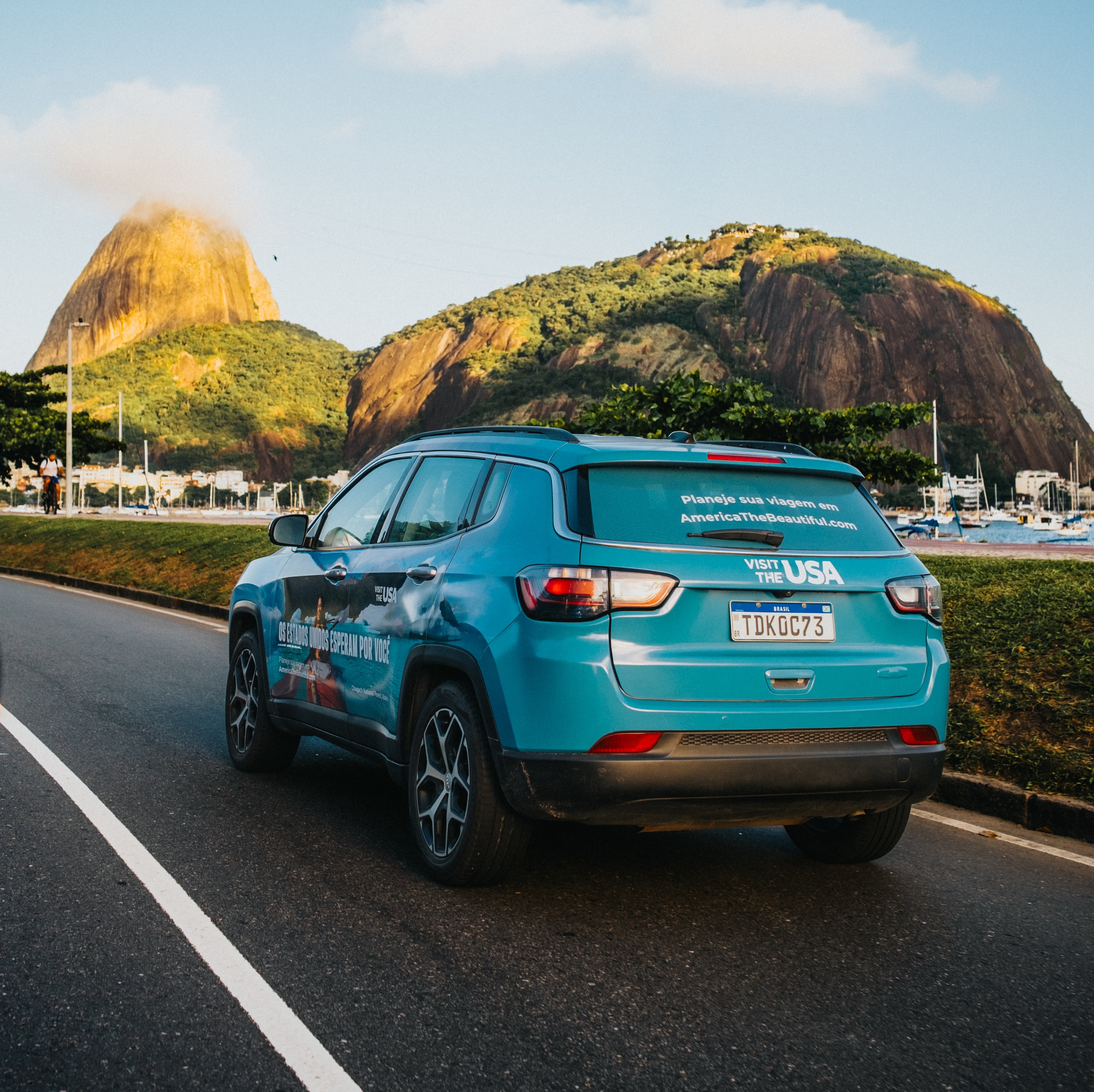 Wrapped car from GOOD TRAFFIC's inaugural OOH campaign in Rio de Janeiro on behalf of Brand USA; image show wrapped car on Brazil highway