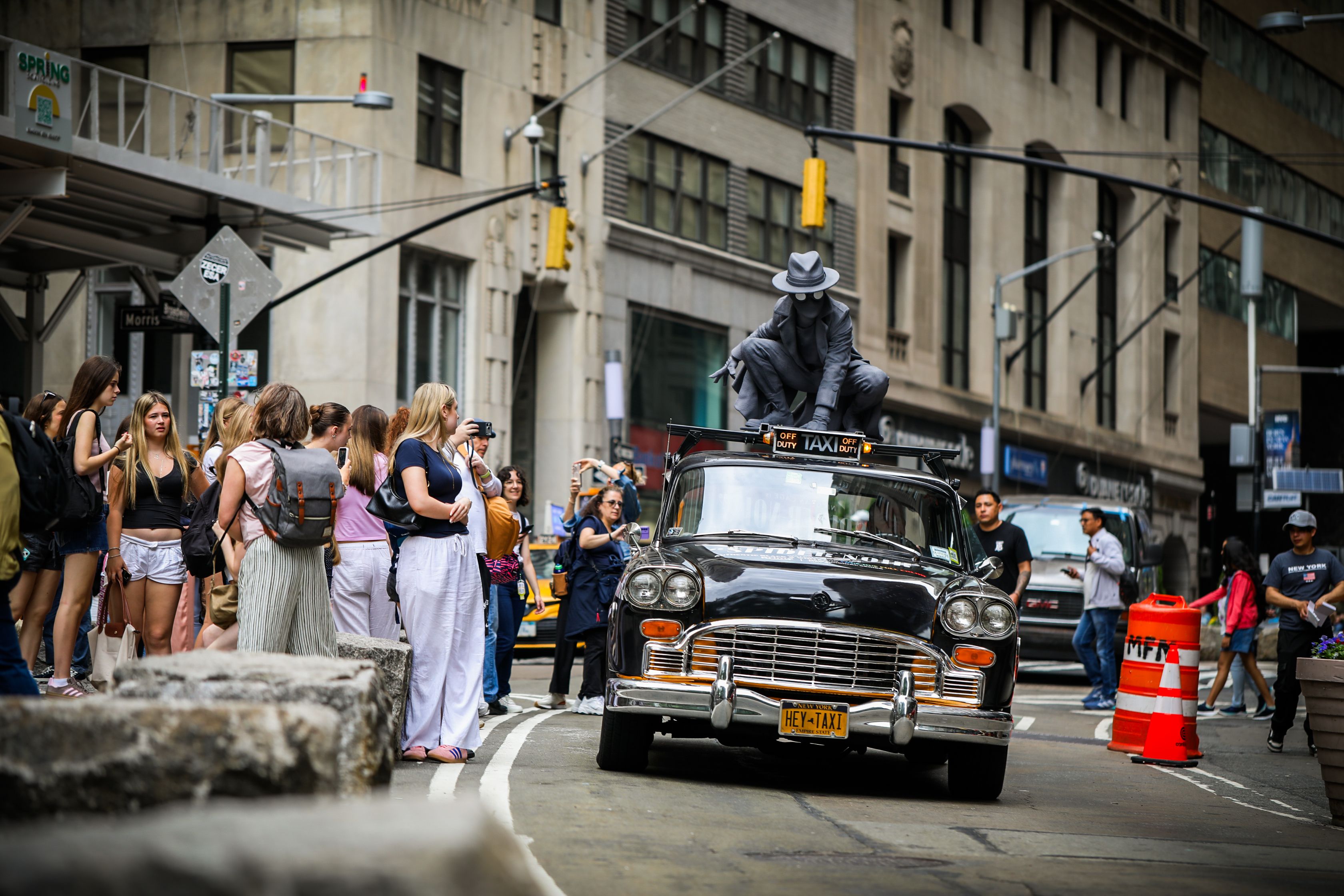 Wrapped specialty vehicle (vintage taxi) with prime video spidernoir 3D topper driving through NYC