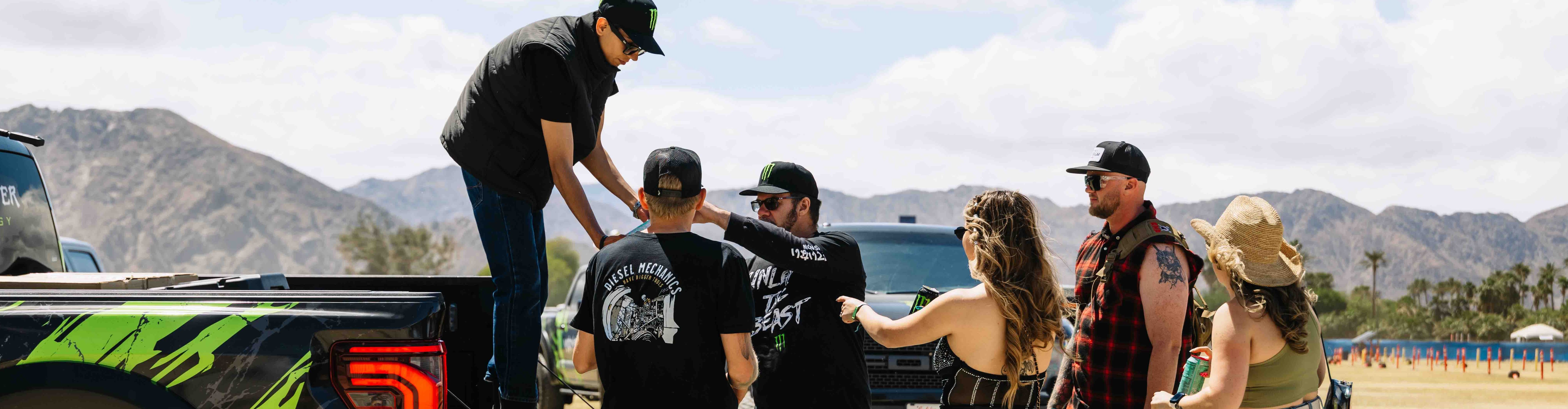Brand ambassador handing out free Monster Energy drinks during a street-level marketing activation in California