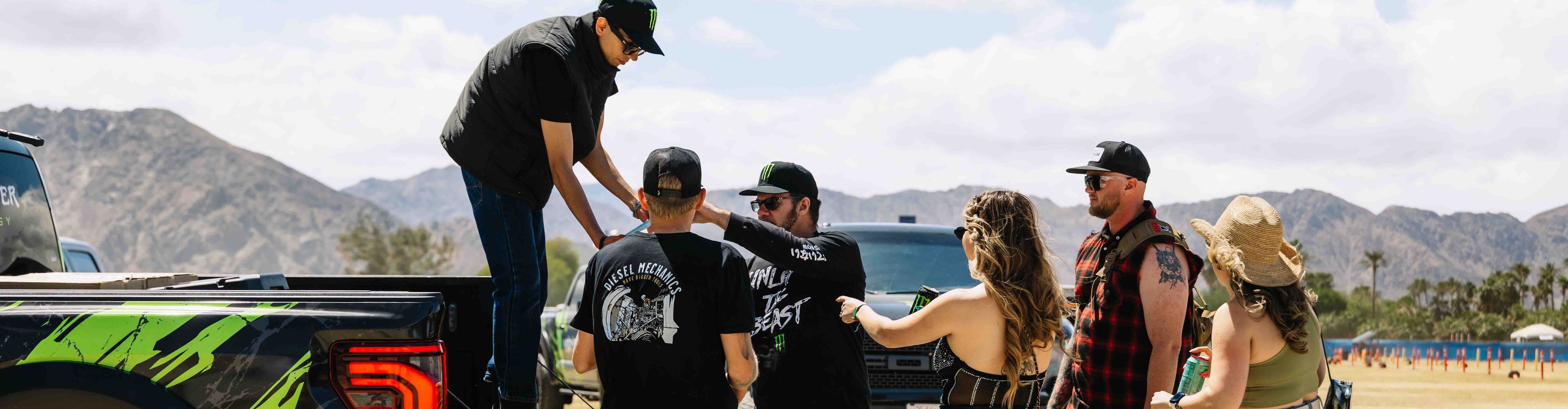 Brand ambassador handing out free Monster Energy drinks during a street-level marketing activation in California