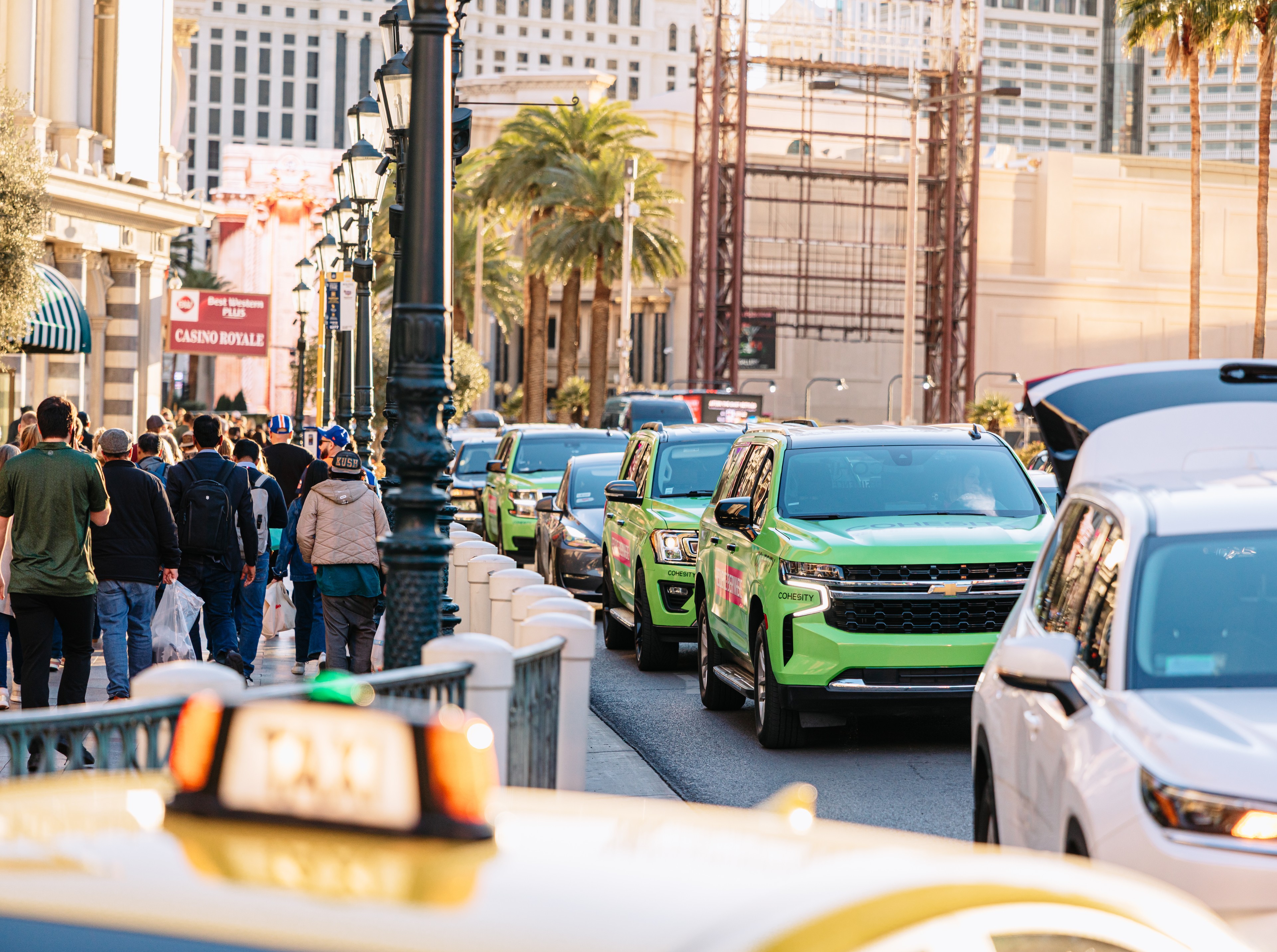 Cohesity-branded neon green SUV fleet driving along the Las Vegas Strip during a brand campaign