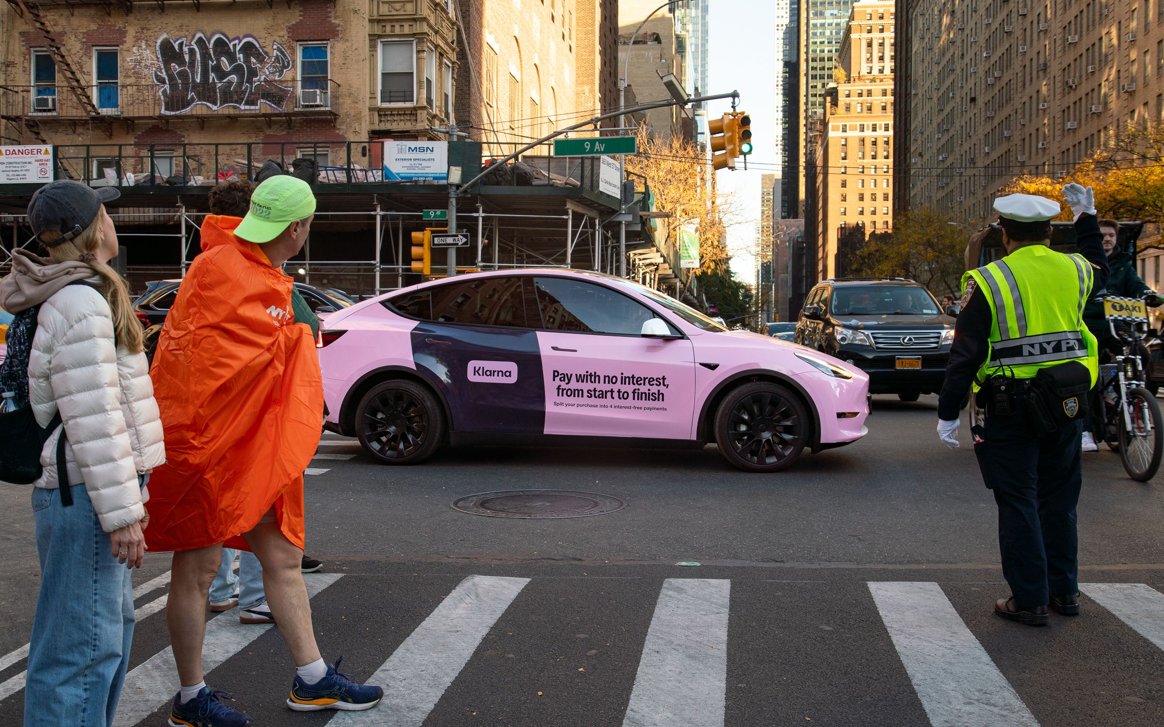 a car in the middle of a city street wrapped in a brand advertisement