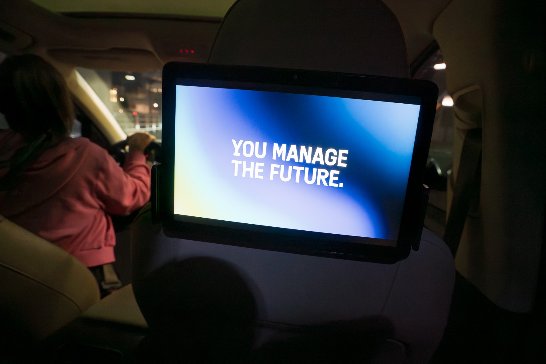 Emburse 'You Manage the Future' branded tablet advertisement displayed on a rideshare headrest screen