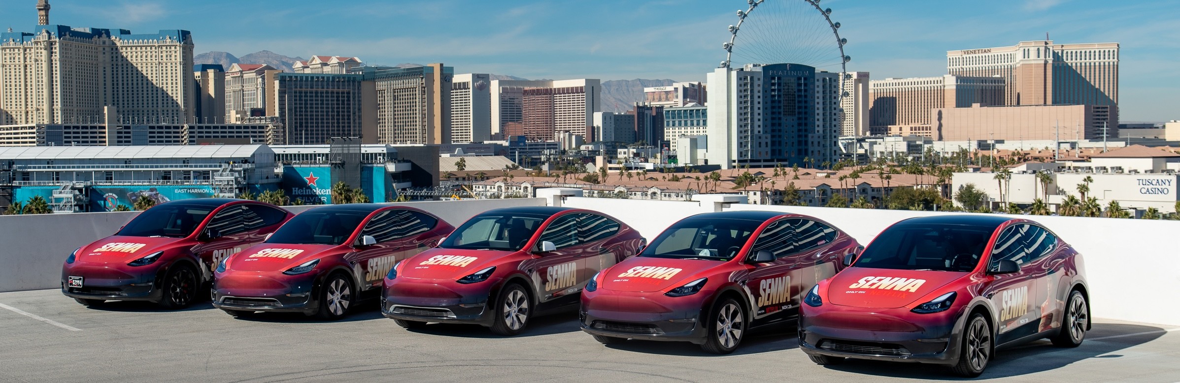 Netflix Senna-branded red Tesla Model Y fleet lined up on a rooftop with the Las Vegas Strip skyline in the background