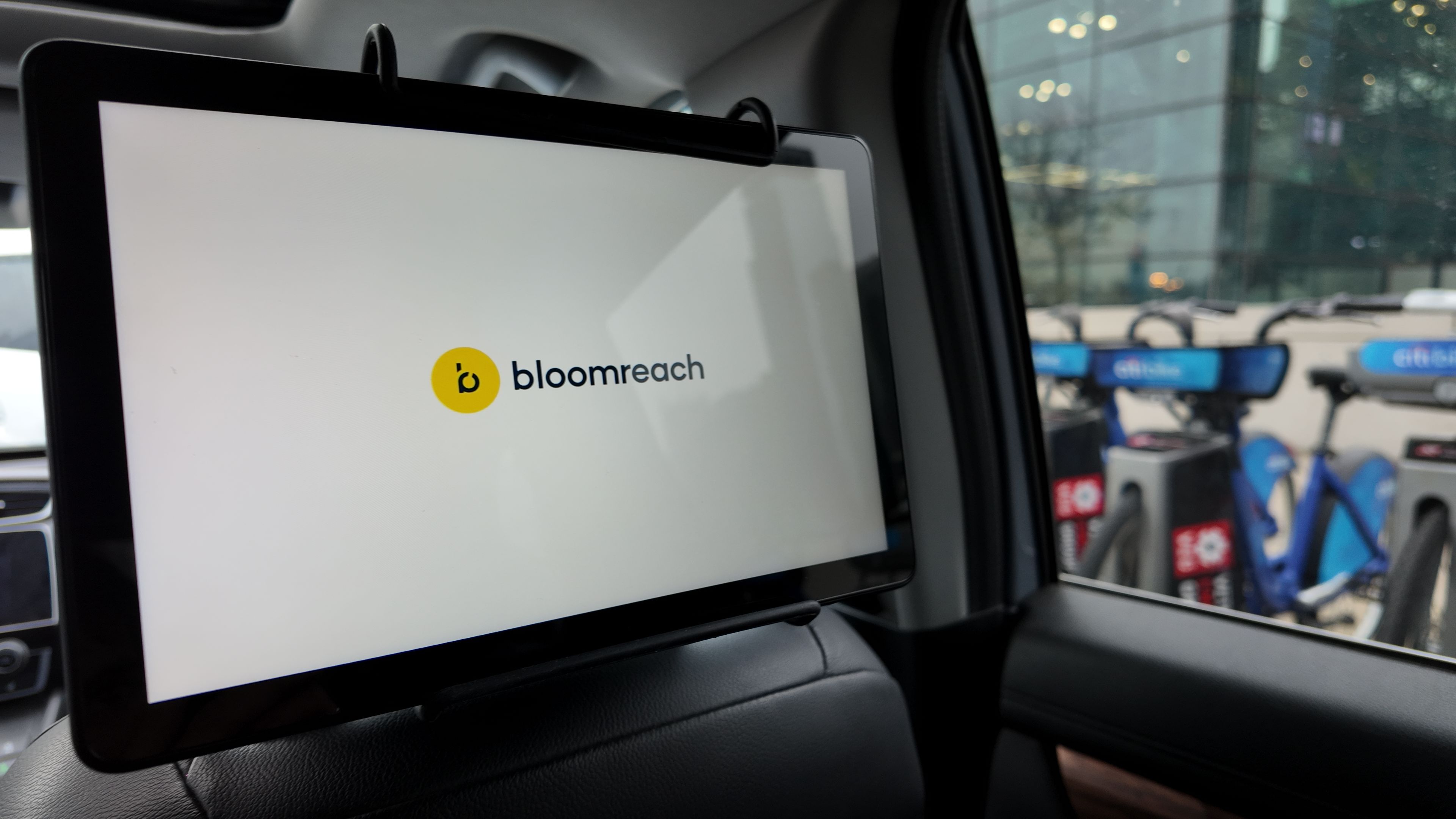 Bloomreach branded tablet advertisement mounted on a rideshare vehicle headrest
