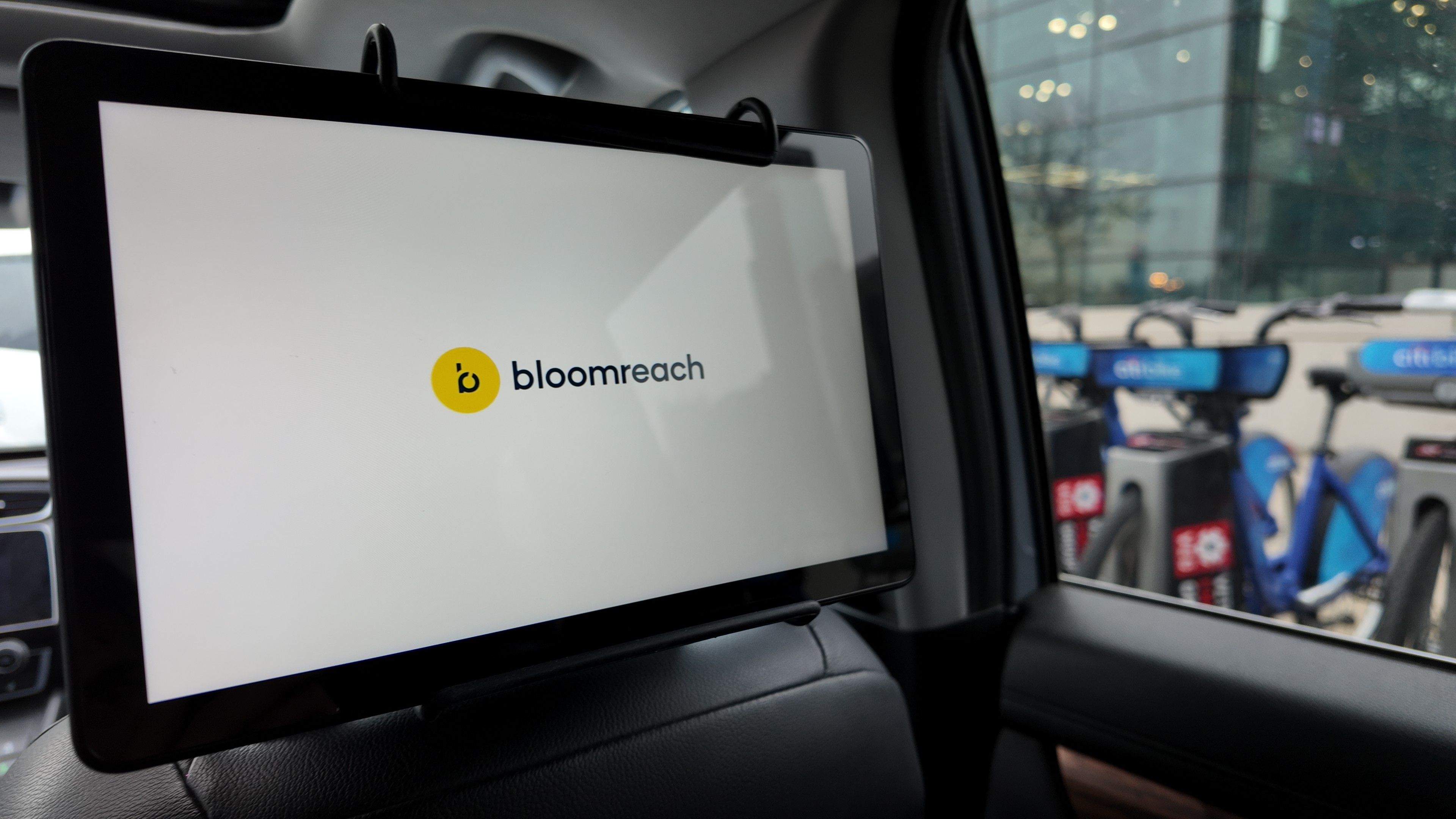 Bloomreach branded tablet advertisement mounted on a rideshare vehicle headrest