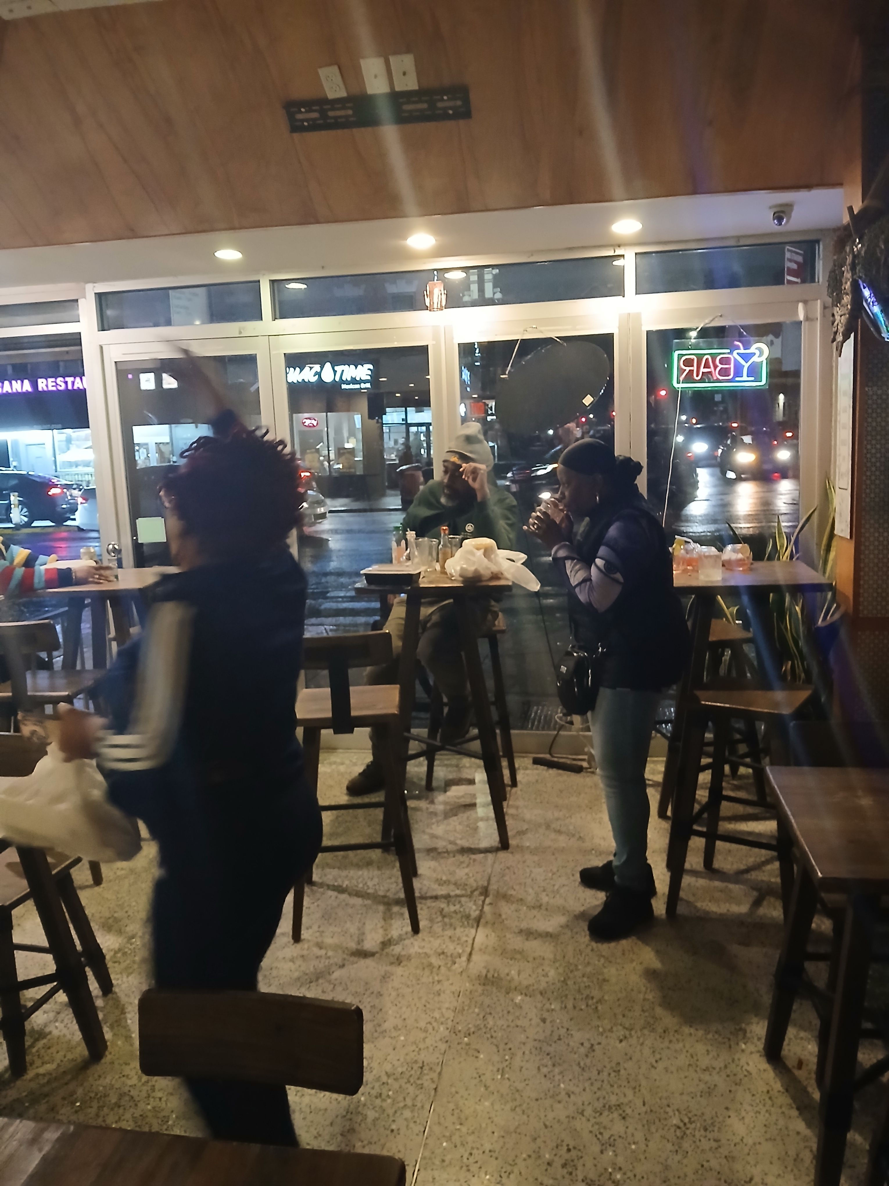  Customers dancing to soca and socializing at Jus Fishy & Beyond, showcasing the vibrant community and soul of the islands on Flatbush Ave.