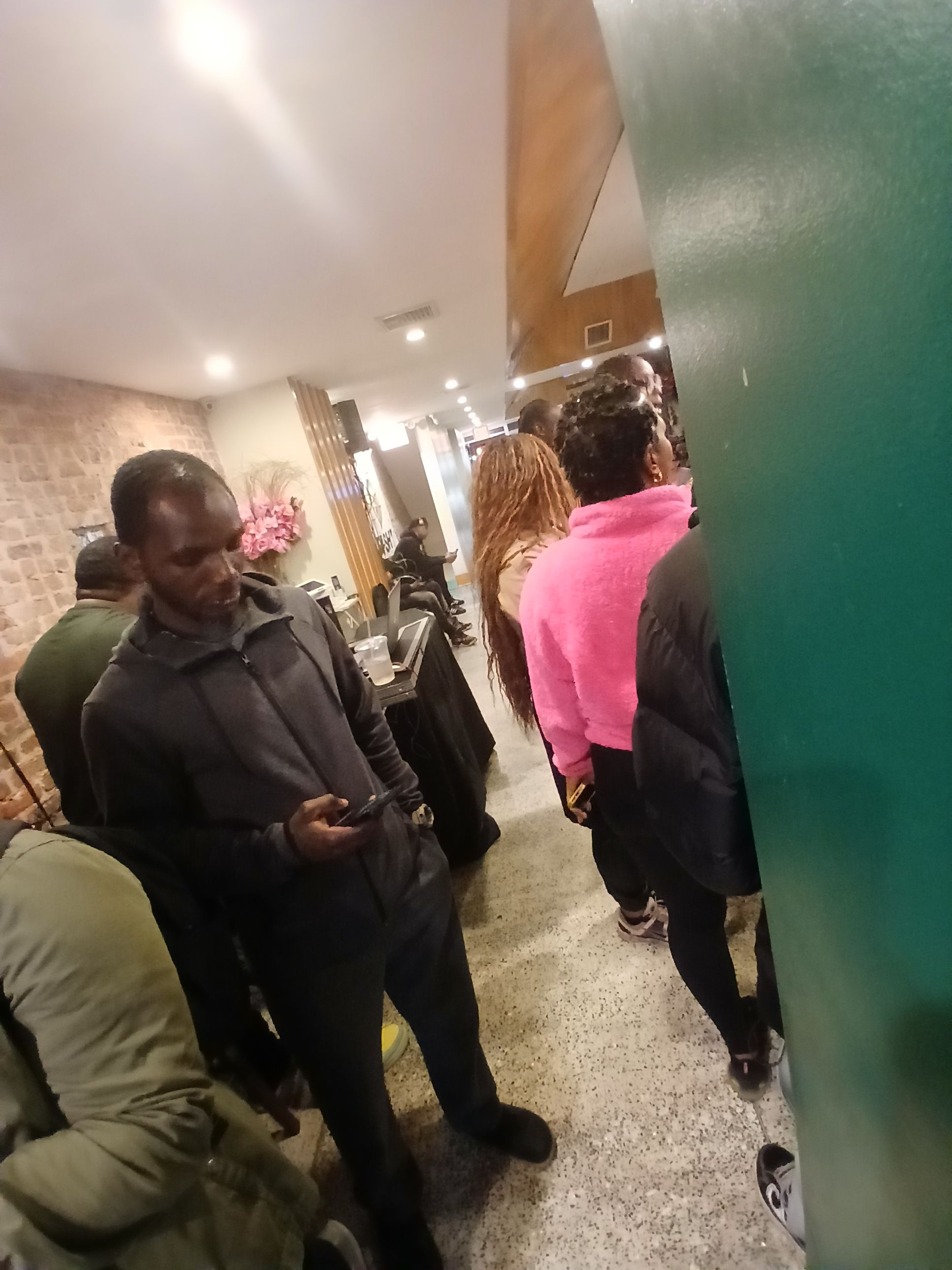  A busy night at Jus Fishy & Beyond on Flatbush Avenue, showing a lively crowd of locals enjoying the atmosphere and fresh seafood.