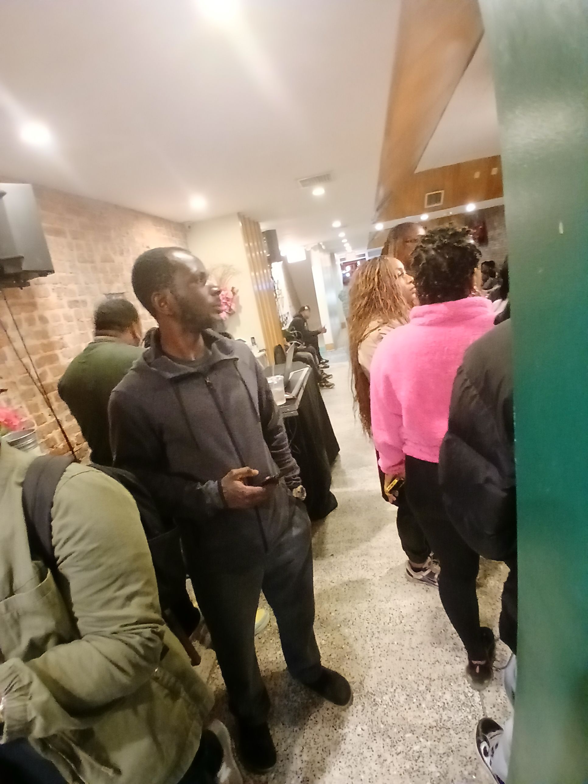 A busy night at Jus Fishy & Beyond on Flatbush Avenue, showing a lively crowd of locals enjoying the atmosphere and fresh seafood.