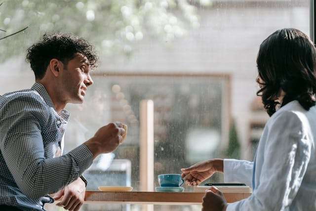 Couple talking near the window - best first date questions