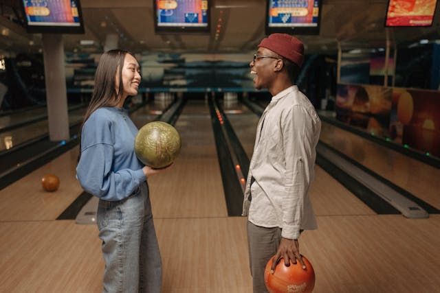 Man and woman playing bowling - first date ideaSource Pexels | Photo by Pavel Danilyuk