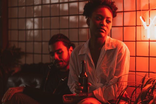 Woman and man in red light - first date ideaSource Pexels | Photo by Ketut Subiyanto