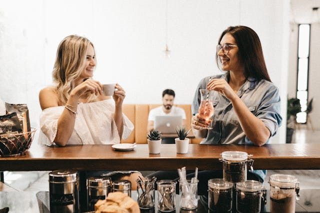 Women sitting at cafe - first date questionSource Pexels | Photo by Jonathan Borba