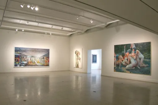 Gallery with artworks installed on the walls and floor