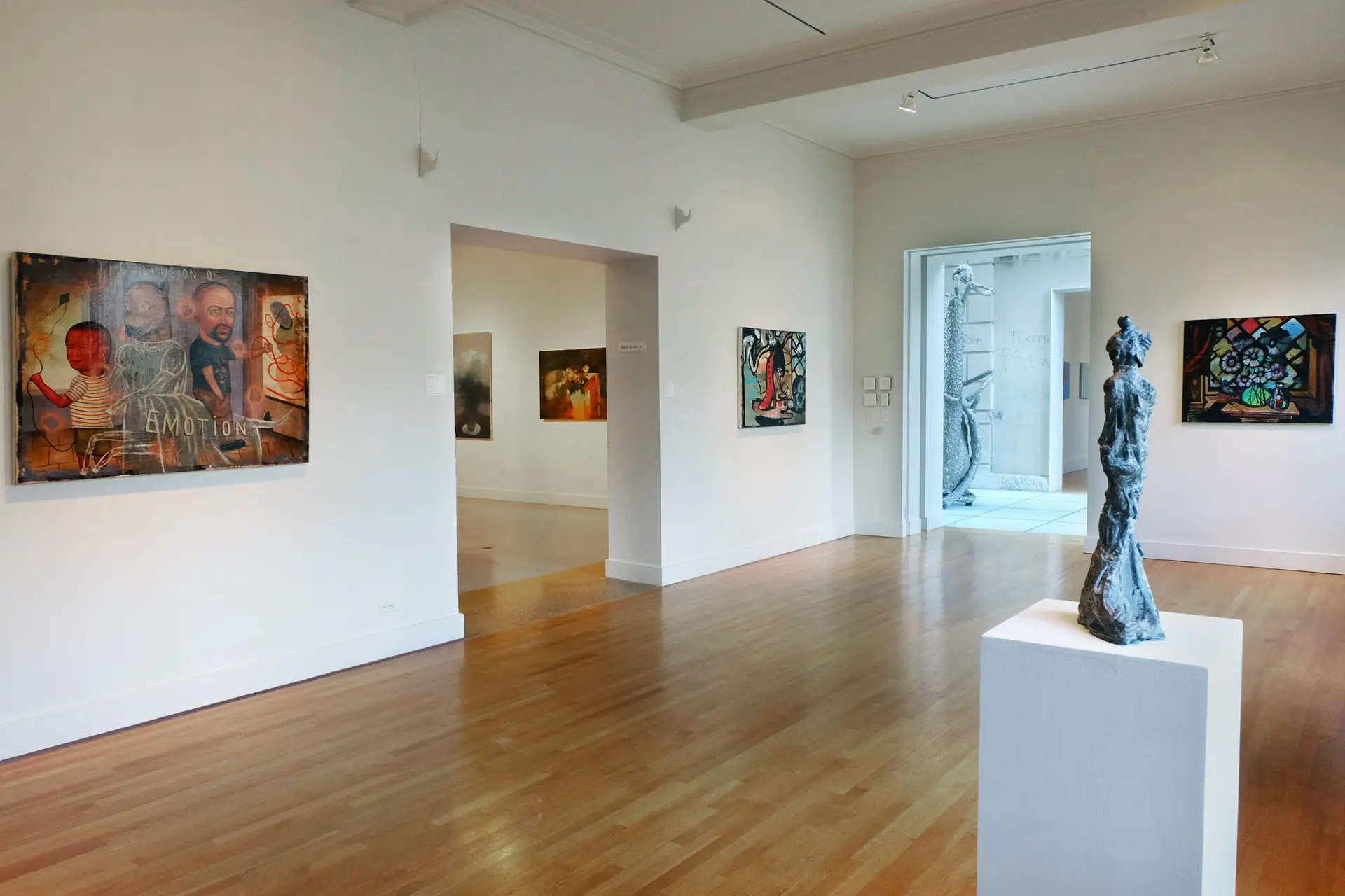 Gallery with artworks installed on the walls and floor.