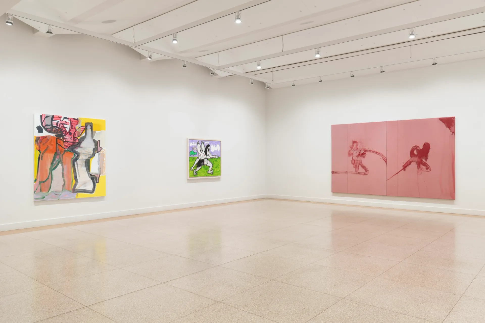 Three colorful paintings hang on a wall. To the left, a large and small piece hang parallel to each other. To the right, a large horizontal artwork takes up the majority of the wall