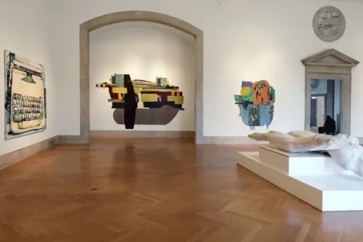 Gallery with artworks installed on the walls and floor.