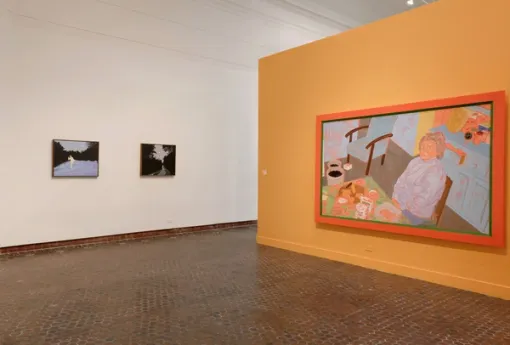 Gallery with artworks installed on the walls and floor.