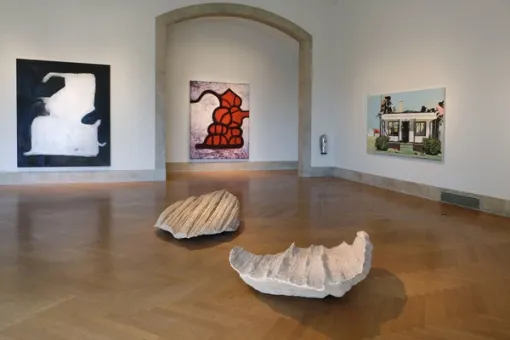 Gallery with artworks installed on the walls and floor