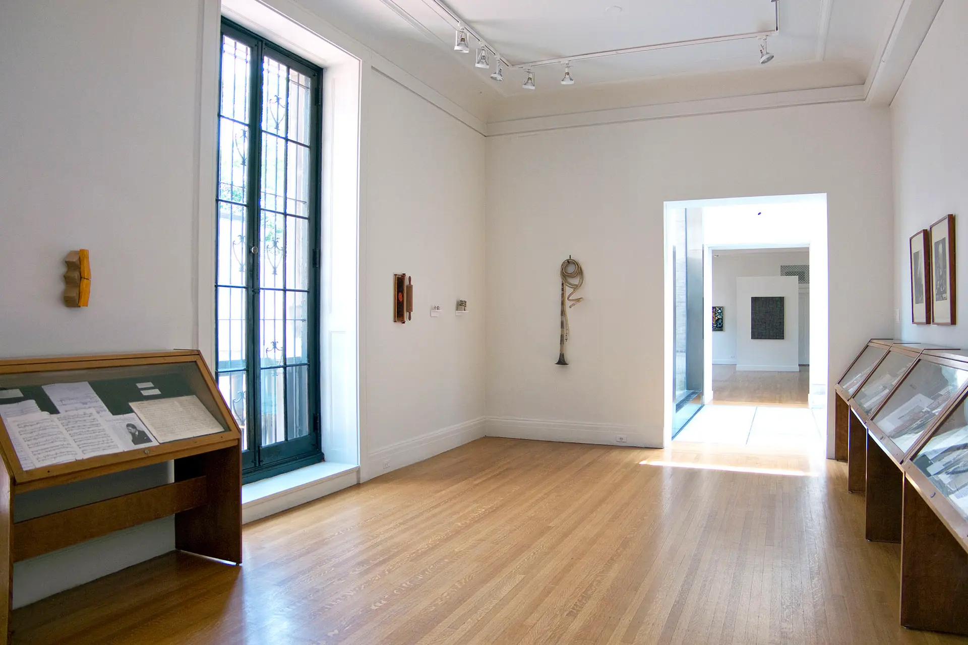 Gallery with artworks installed on the walls and floor.