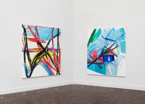 Two large rectangular paintings with colorful abstractions hang beside each other.