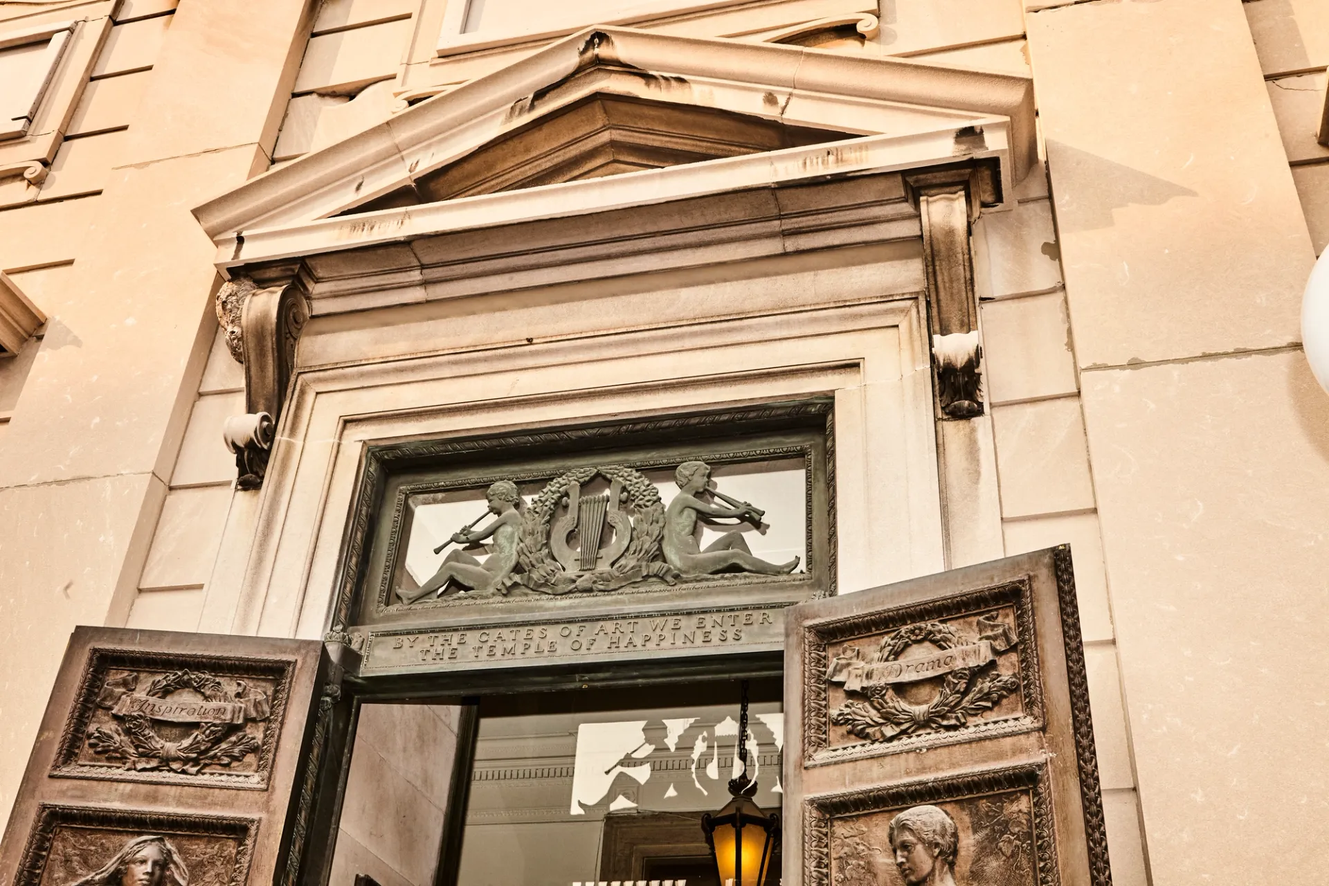 Bronze doors to the American Academy of Arts and Letters with the inscription, "By the gates of art we enter the temple of happiness."