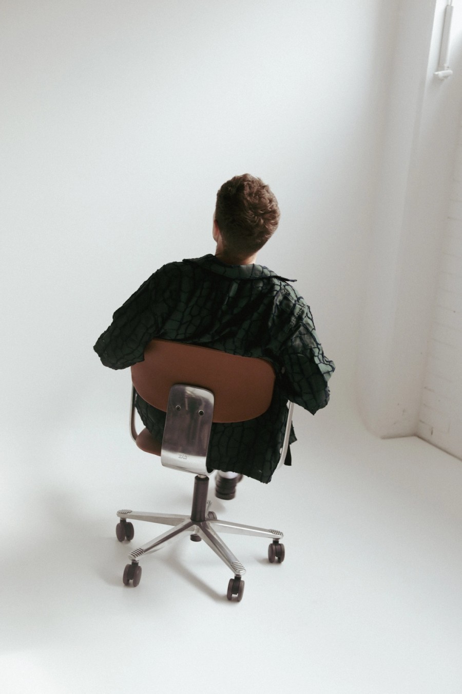 Mitchell Jones, facing backwards on a chair.