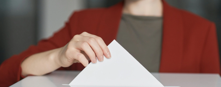 Woman casting a voting ballot