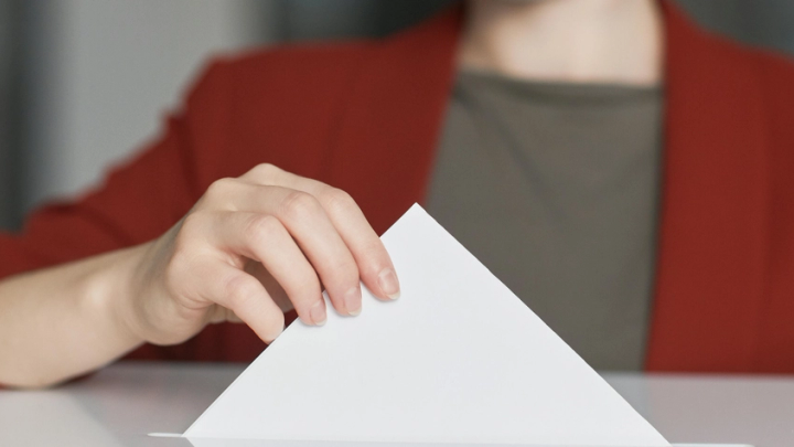 Woman casting a voting ballot