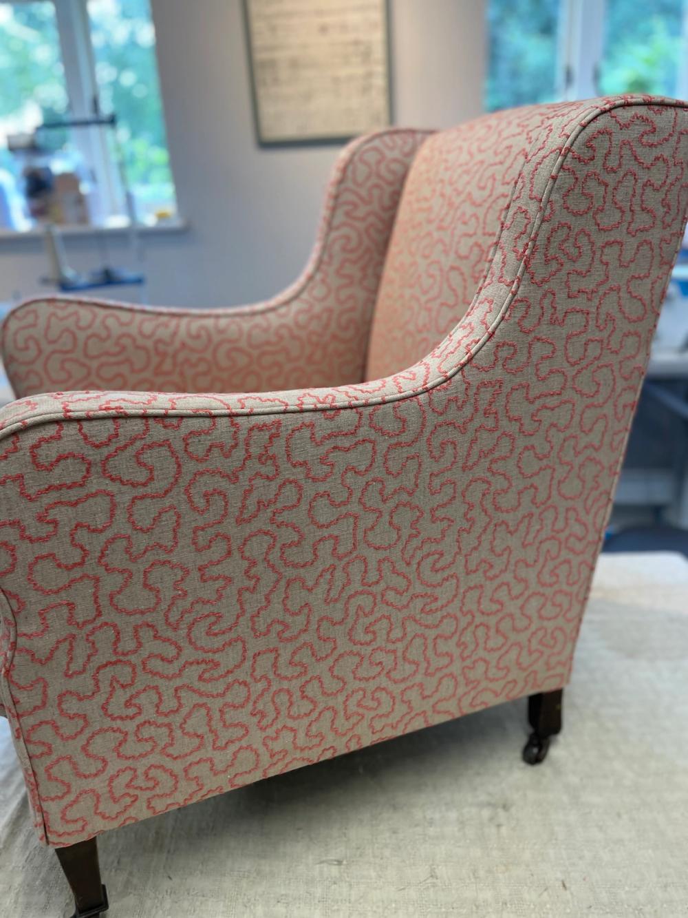 Modern style armchair upholstered in light red waves fabric