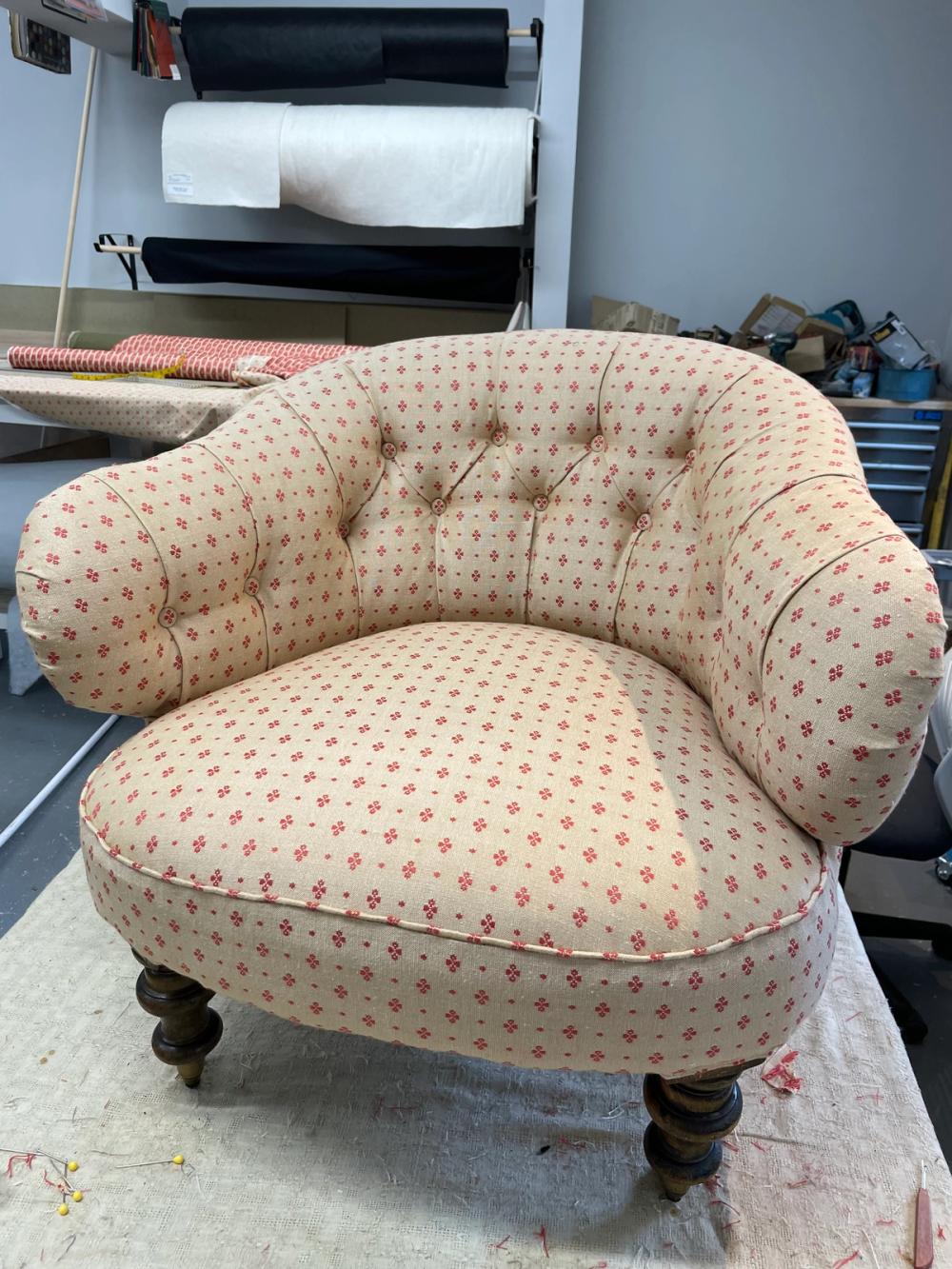 Low button backed armchair in red and beige pinstripe fabric