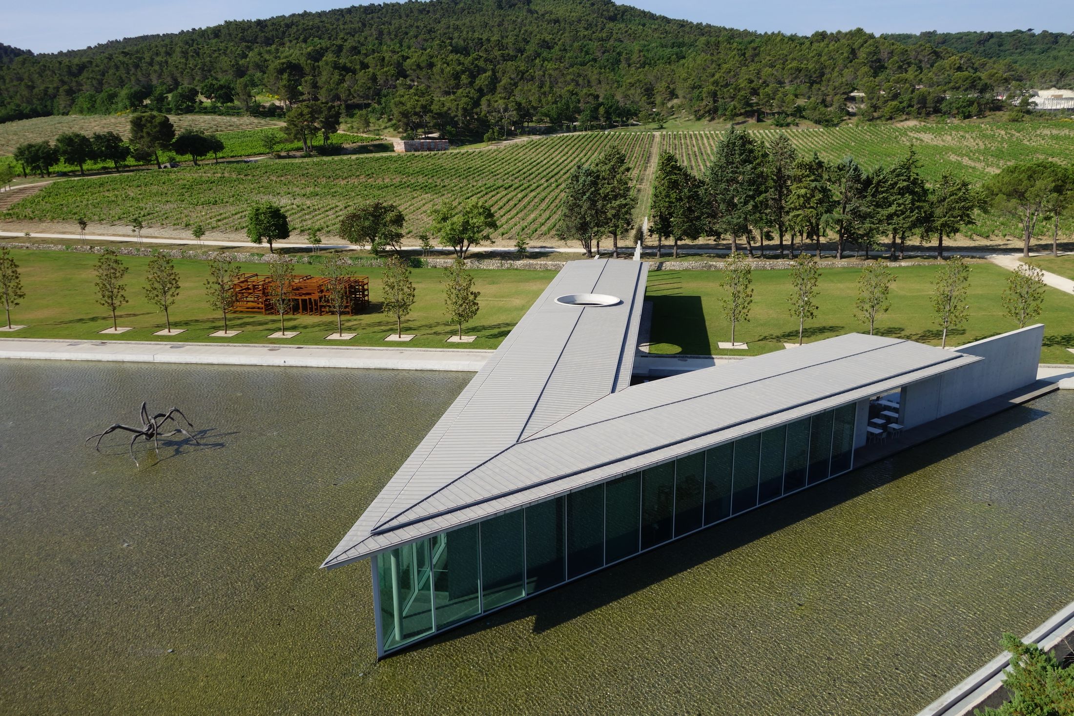 A modern triangle shaped sharp building set in a vineyard