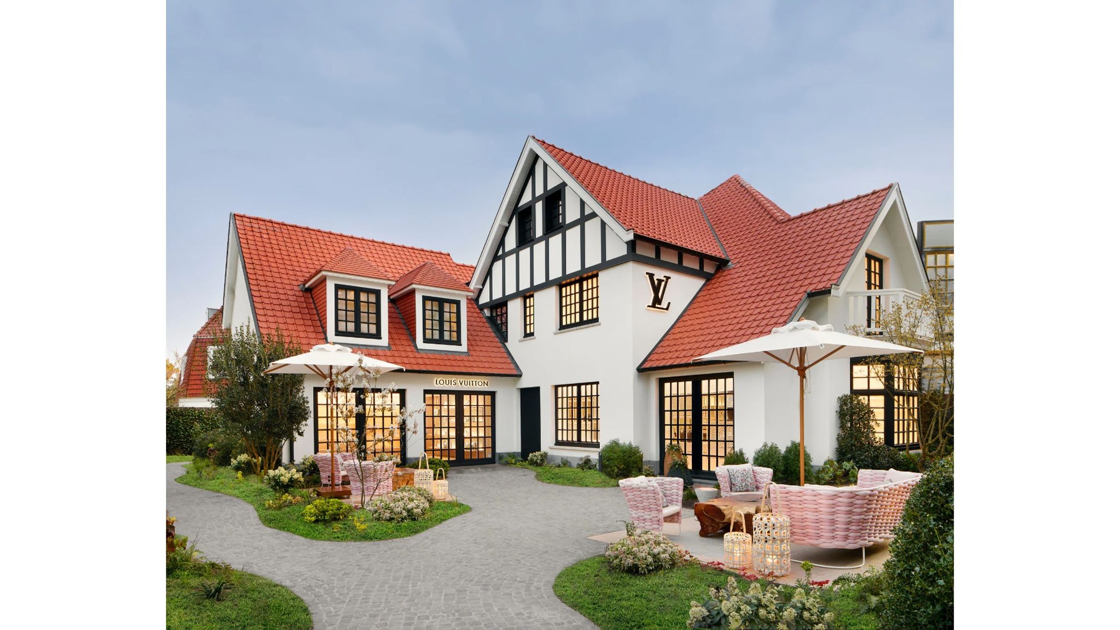 a Louis Vuitton store in a dutch style house with pink outdoor furniture 