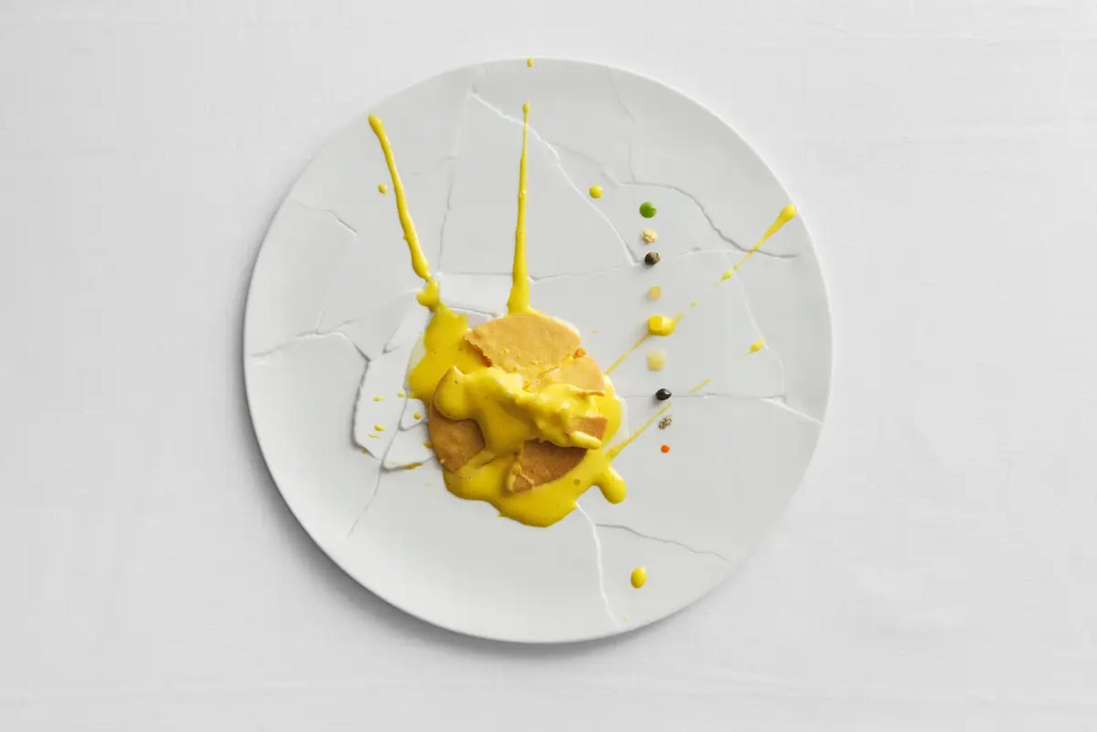 A lemon tart smashed on a plate