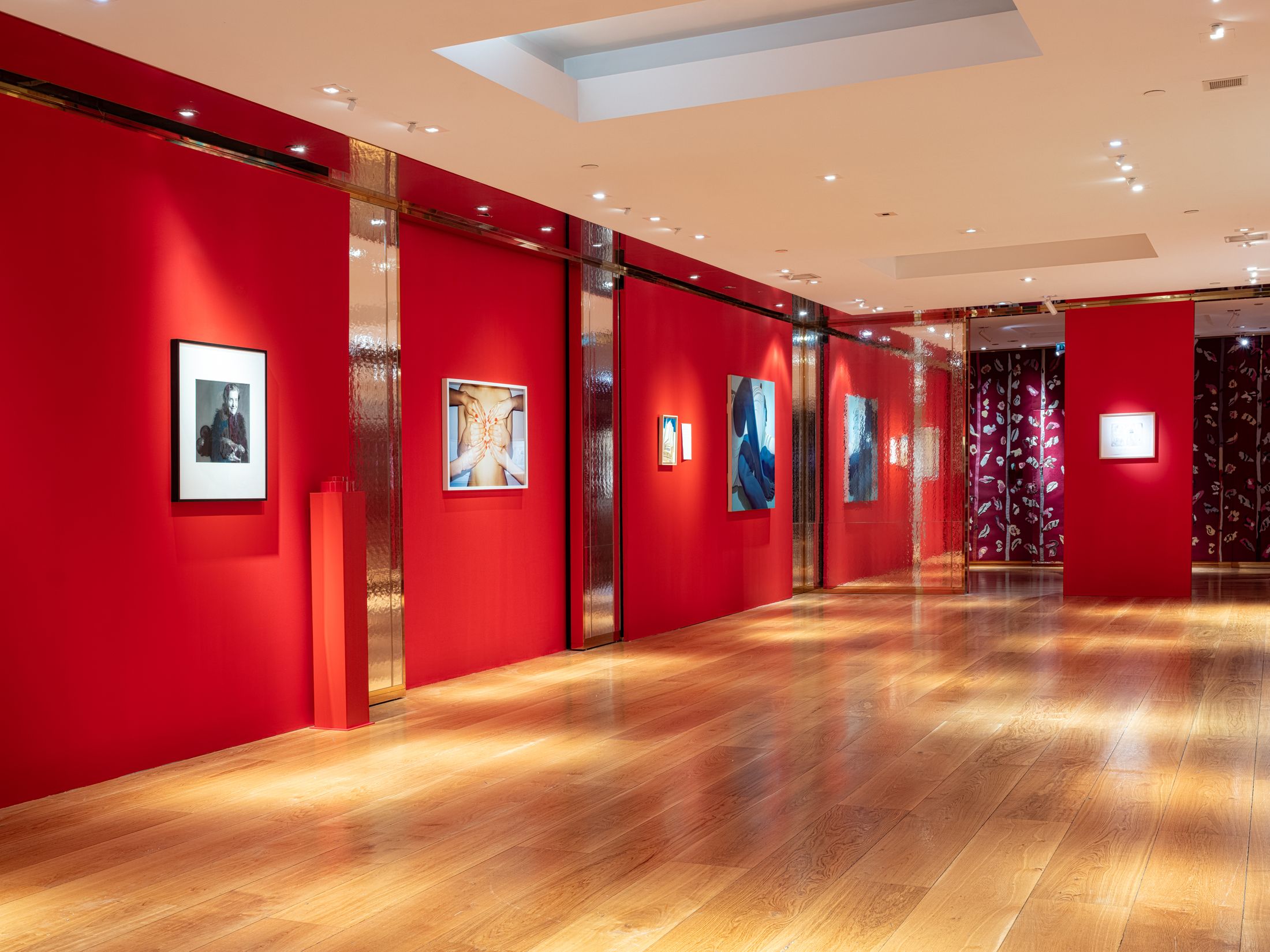 A red room with art on the walls