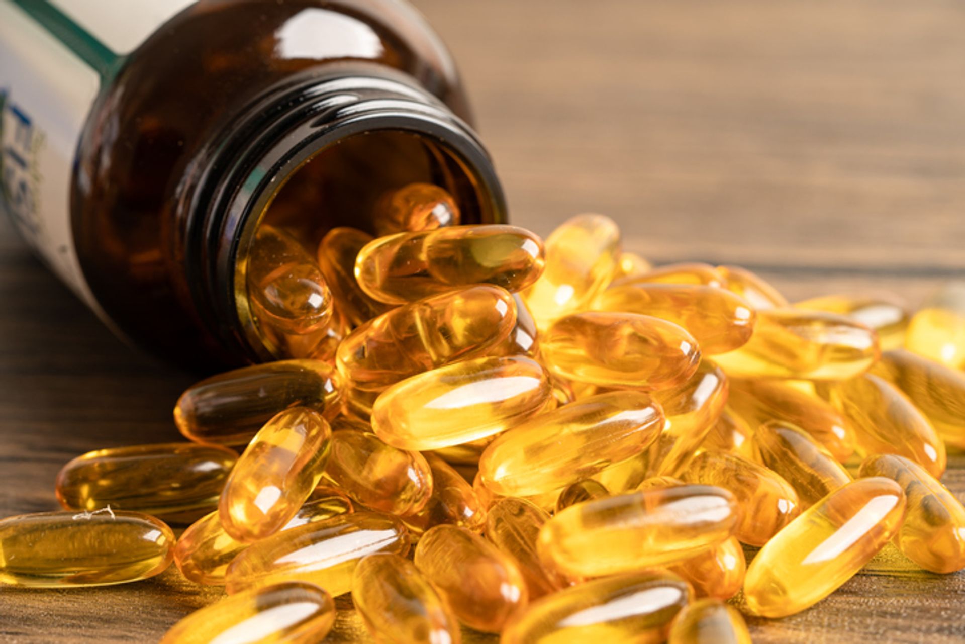Fish oil supplements, bottle, spilling out