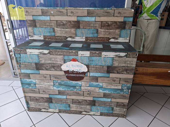 Rustic wooden display/storage unit with a distressed grey, brown and turquoise finish