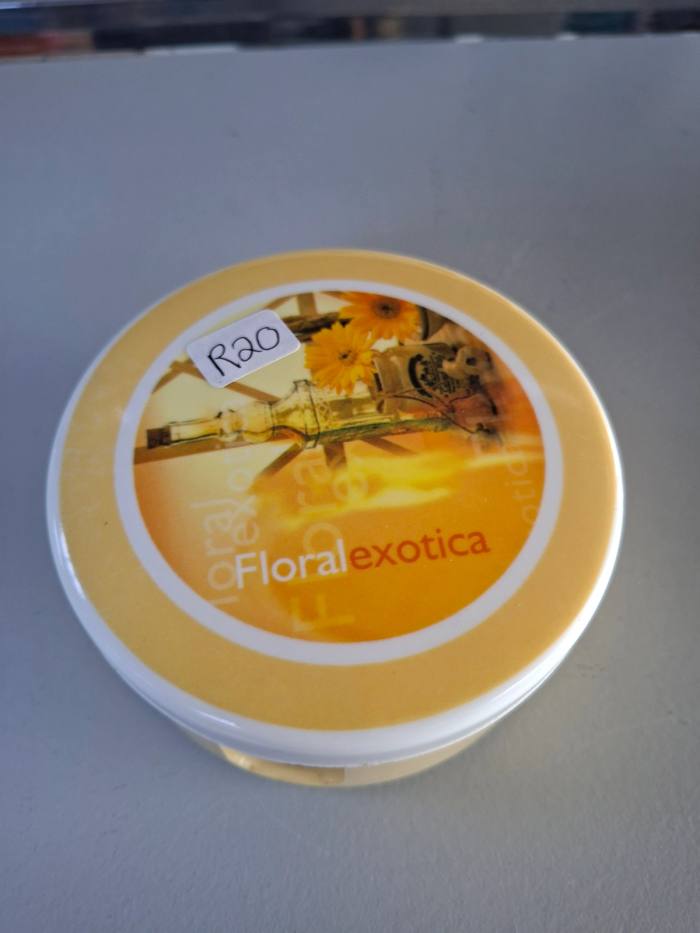 Round floral-themed coaster set with matching storage holder and lid.