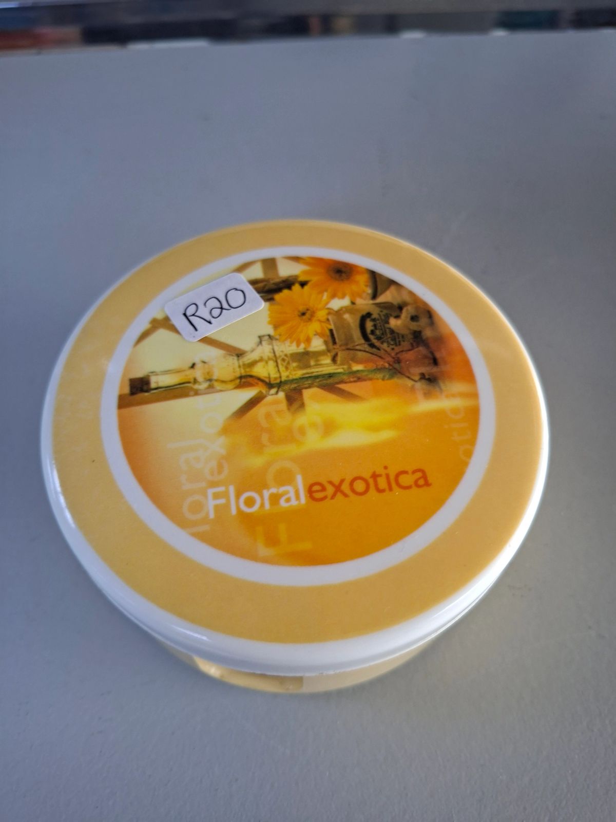 Round floral-themed coaster set with matching storage holder and lid.