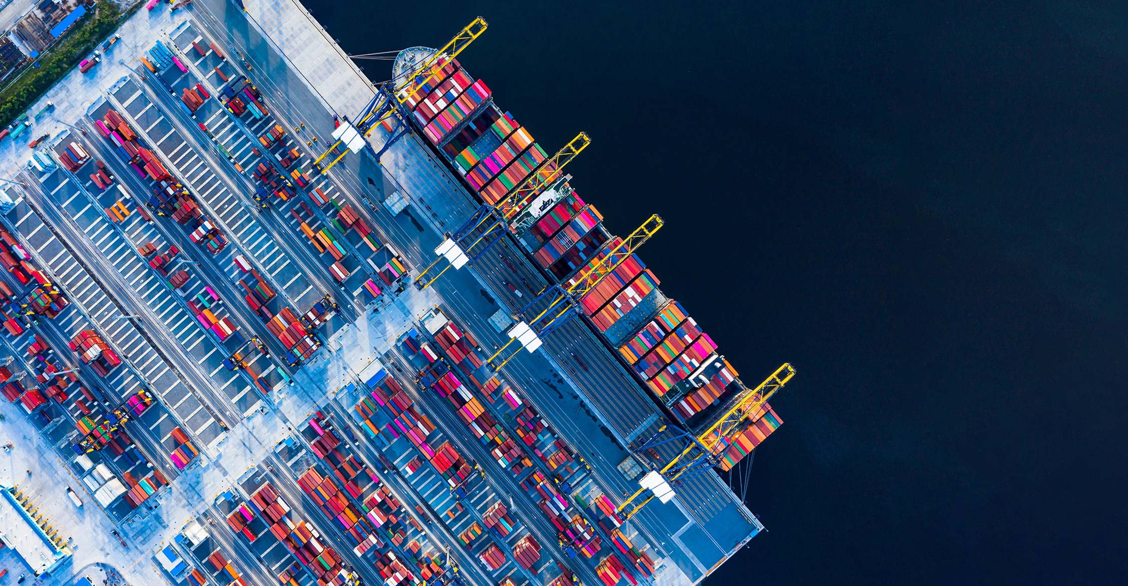 aerial shot of cargo ship being loaded with cargo